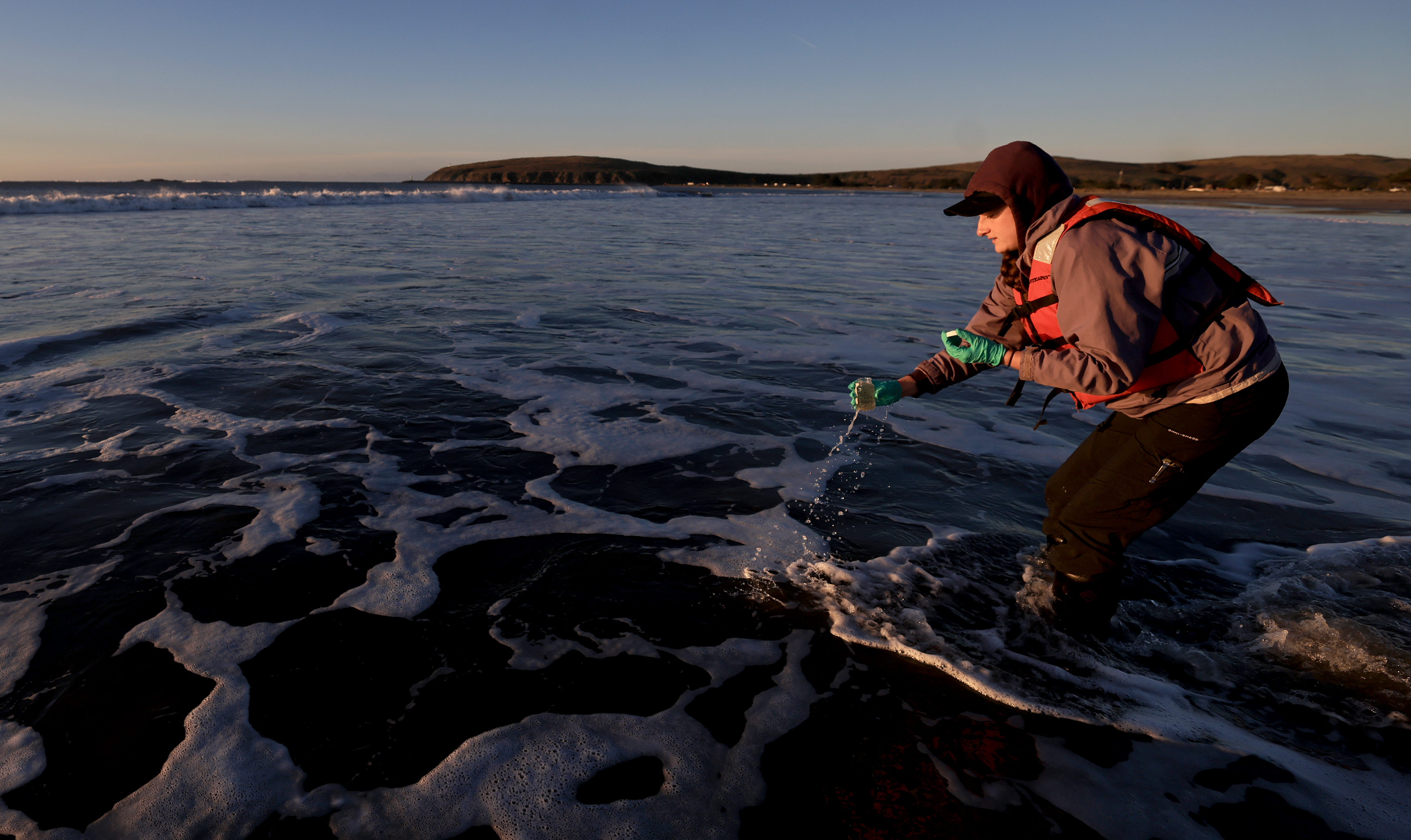 Ellyse Cappellano, county environment health specialist, takes a sample of...