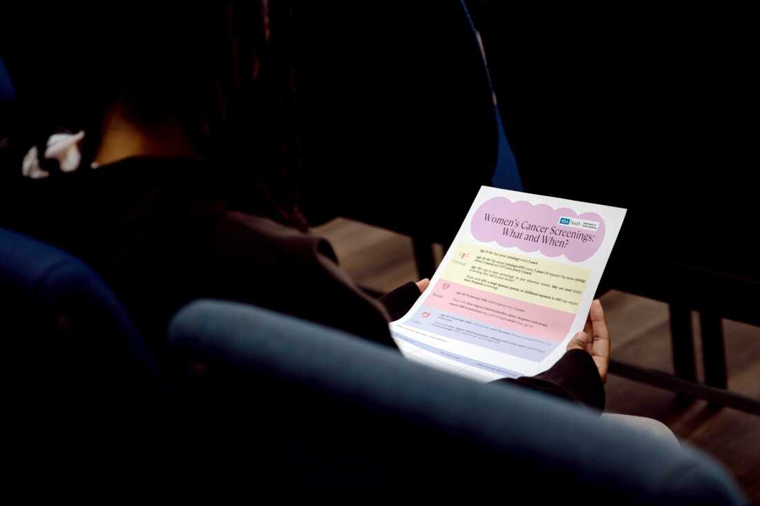 A resident at the Union Rescue Mission reviews a flyer that providing information on different types of cancers and their risks. December 15, 2025