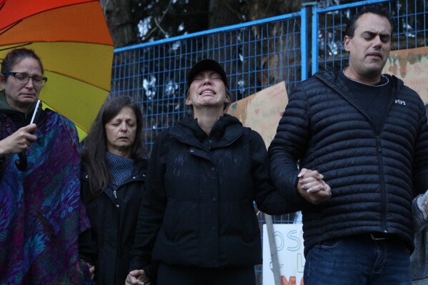 Katie Pasitney, the daughter of one of the co-owners of Universal Ostrich Farms, participates in a group prayer in Edgewood, B.C., following the announcement that the Supreme Court of Canada dismissed the farm's appeal to stay an order to cull more than 300 of its ostriches on Thursday, Nov. 6, 2025. (Aaron Hemens /The Canadian Press via AP)