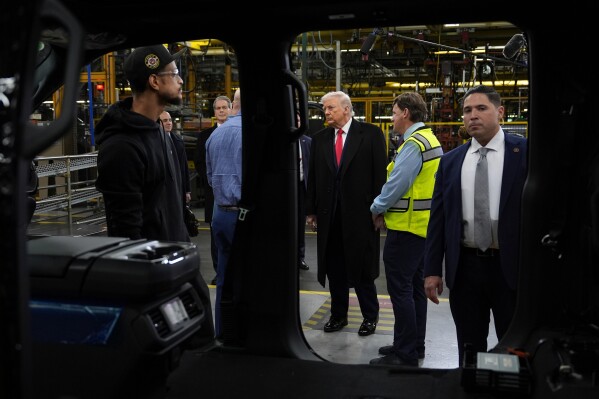 President Donald Trump listens during a tour of the Ford River Rogue complex, Tuesday, Jan. 13, 2026, in Dearborn, Mich. (AP Photo/Evan Vucci)
