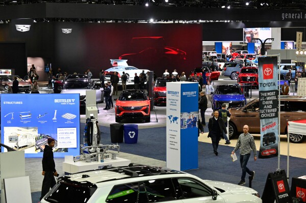Guests and members of the media walk the floor at the Detroit Auto Show, Wednesday, Jan. 14, 2026, in Detroit. (AP Photo/Jose Juarez)