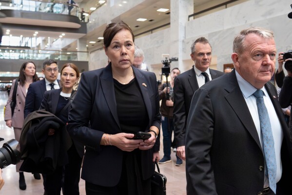From center to right, Greenland Foreign Minister Vivian Motzfeldt, Denmark's Ambassador Jesper Møller Sørensen, rear, and Danish Foreign Minister Lars Løkke Rasmussen, right, arrive on Capitol Hill to meet with senators from the Arctic Caucus, in Washington, Wednesday, Jan. 14, 2026. (AP Photo/J. Scott Applewhite)
