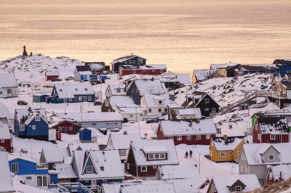 People walk on a street in Nuuk, Greenland, Wednesday, Jan. 14, 2026. (AP Photo/Evgeniy Maloletka)