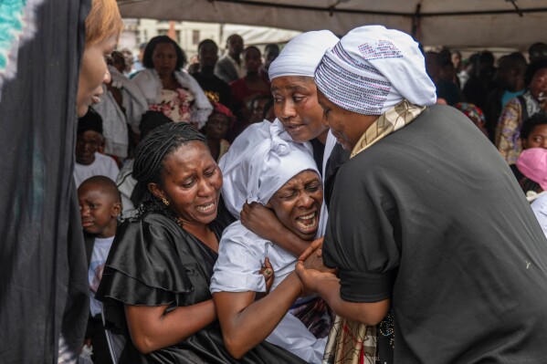 The families of victims mourn at the funeral service for civilians killed in a drone strike in Goma, Democratic Republic of Congo, Thursday, Jan. 8, 2026. (AP Photo/Moses Sawasawa)