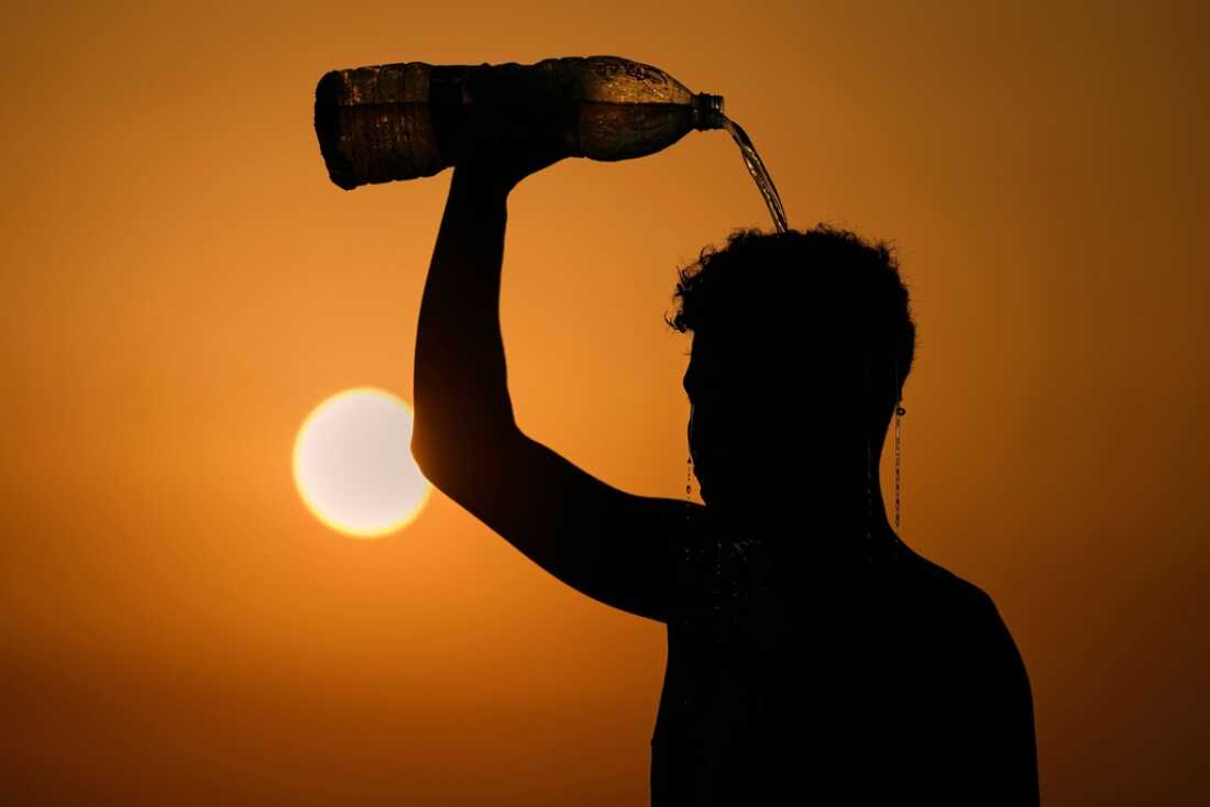 A man rinses with water in August after playing beach footvolley on the Ramlet al-Baida public beach in Beirut, Lebanon,, on a sweltering hot day.