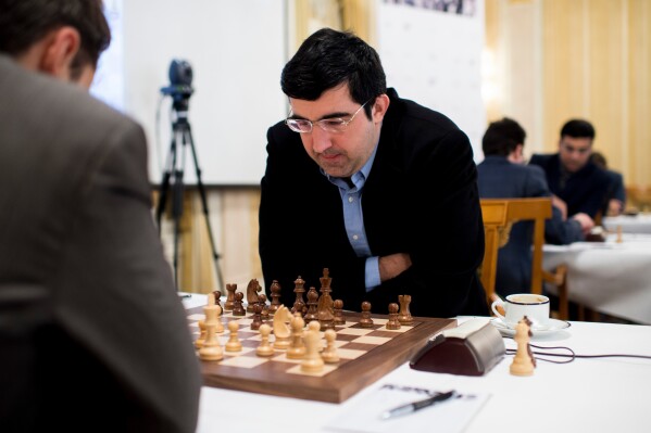 Russian chess grandmaster Vladimir Kramnik, right, concentrates during his game against U.S. grandmaster Lewon Aronjan during the Zurich Chess Challenge 2015 Round 3 in Zurich, Feb. 16, 2015. (Ennio Leanza/Keystone via AP)