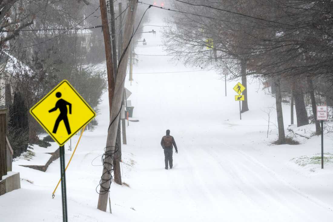 A person walks in the snow on January 24, 2026 in Little Rock, Arkansas. A massive winter storm is bringing frigid temperatures, ice, and snow to nearly 200 million Americans.