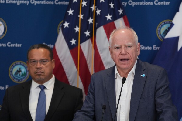 Minnesota Gov. Tim Walz, right, and Attorney General Keith Ellison discuss the shooting of Alex Pretti during a news conference in Blaine, Minn., Sunday, Jan. 25, 2026. (AP Photo/Abbie Parr)