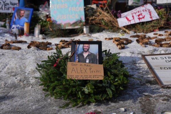 A makeshift memorial is placed where Alex Pretti was fatally shot by a U.S. Border Patrol officer yesterday, in Minneapolis, Sunday, Jan. 25, 2026. (AP Photo/Adam Gray)