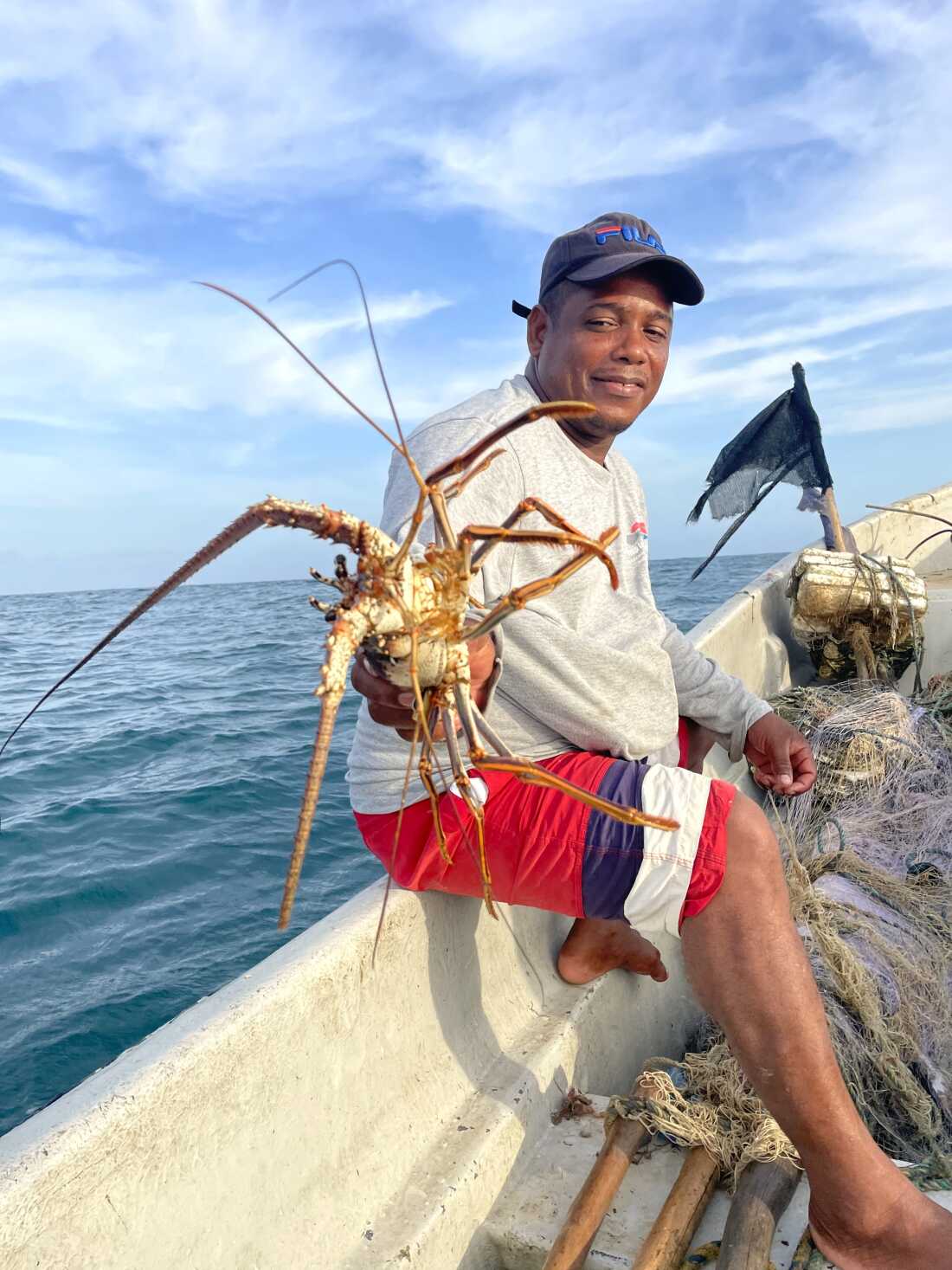 Euris Cervantes, a Colombian fisherman, displays one of his day’s catch — a lobster — in the Caribbean waters near Punta Canoa.