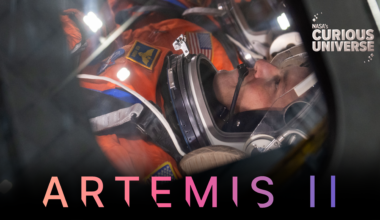 Close-up image of Reid Wiseman, Artemis II commander, wearing an orange spacesuit and clear helmet. The words "Artemis II" are across the bottom of the image and the Curious Universe logo is in the upper right corner.