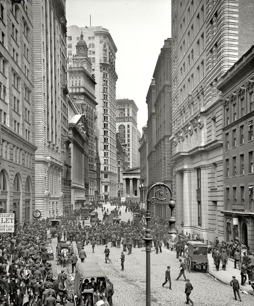 New York’s Financial District in the early 20th century. Note the exclusively male pedestrians, then the mark of a commercial area as opposed to a retail or residential one.
