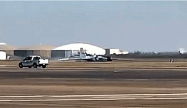 A NASA aircraft performing a gear-up landing on an airport runway.