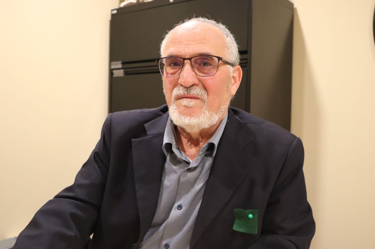 A man looks at the camera