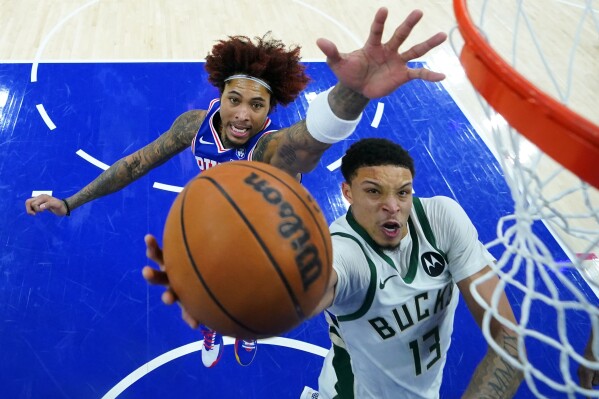 Milwaukee Bucks' Ryan Rollins, right, goes up for a shot against Philadelphia 76ers' Kelly Oubre Jr. during the second half of an NBA basketball game Tuesday, Jan. 27, 2026, in Philadelphia. (AP Photo/Matt Slocum, File)