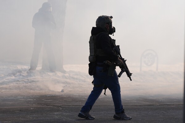 Federal immigration officers deploy tear gas after a shooting Saturday, Jan. 24, 2026, in Minneapolis. (AP Photo/Abbie Parr, File)