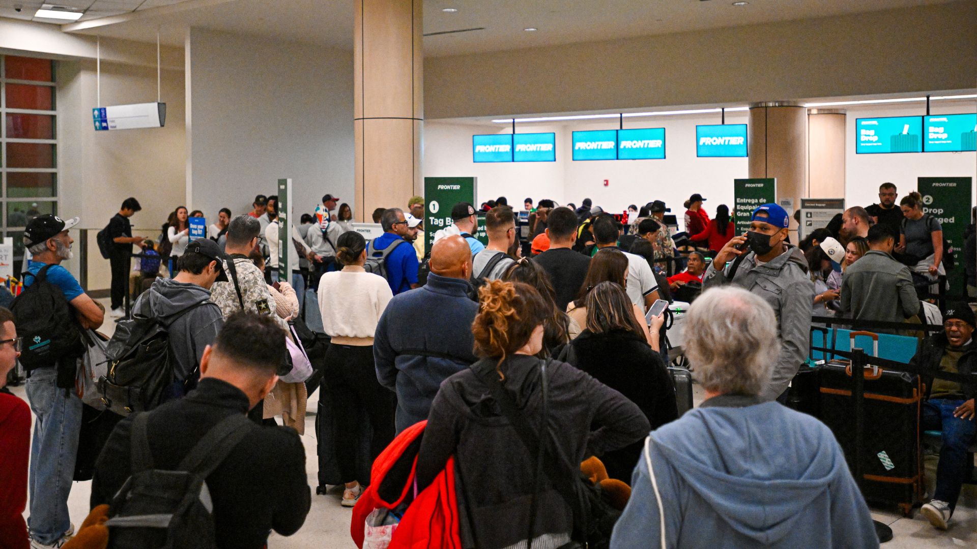 Passengers wait at Luis Munoz Marin International Airport as all flights are cancelled following US military action in Venezuela, on January 3, 2026, in Carolina, Puerto Rico