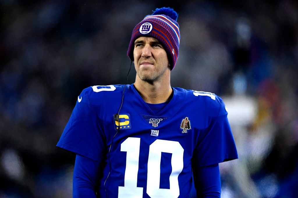 Eli Manning wearing a New York Giants beanie and jersey.