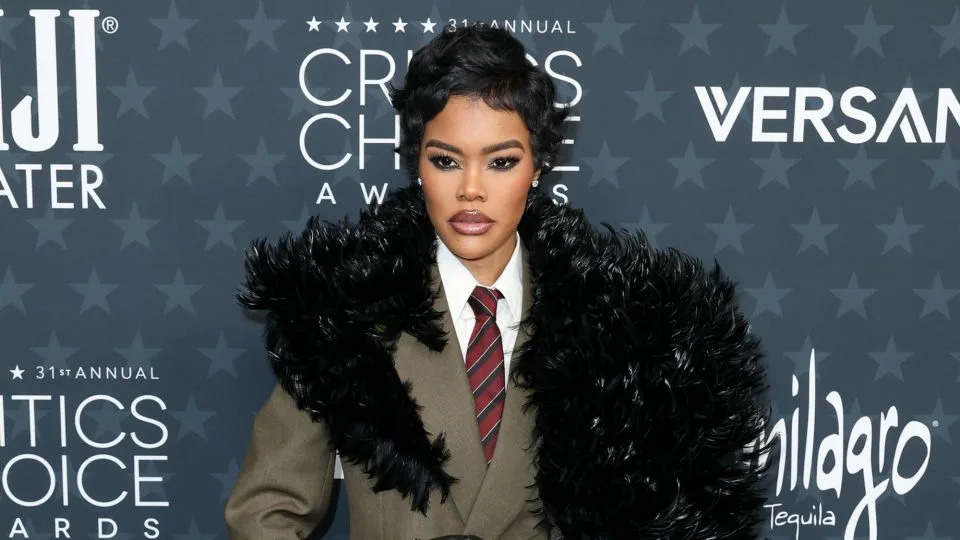 Complete with leather gloves, thigh-high boots and striped necktie, Teyana Taylor's feathery suit was adapted from Saint Laurent's Fall-Winter 2025 menswear line. - JC Olivera/WWD/Getty Images