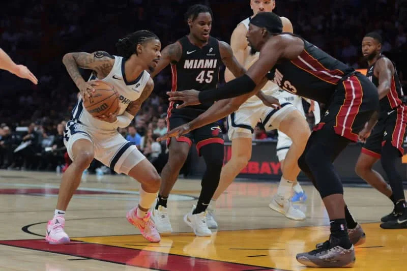 Apr 3, 2025; Miami, Florida, USA; Memphis Grizzlies guard Ja Morant (12) drives to the basket against Miami Heat center Bam Adebayo (13) during the second quarter at Kaseya Center. Mandatory Credit: Sam Navarro-Imagn Images