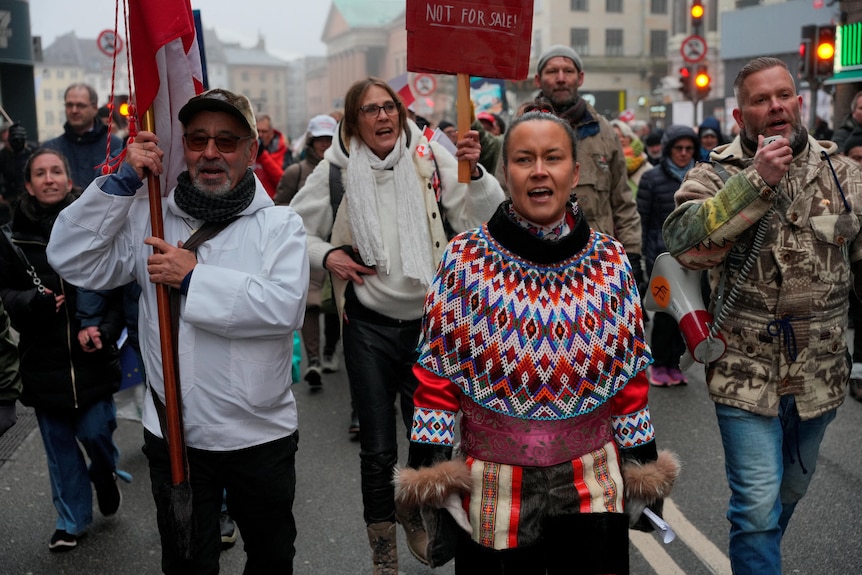People marching through the streets of Copenhagen under slogans 'Hands off Greenland'.