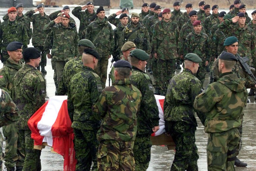 Soldiers of the International Security Assistance Force salute the coffin of a Danish soldier during a ceremony at Kabul's military airport in March 2002. Two German and three Danish ISAF soldiers were killed in an explosion near the German base in Kabul.