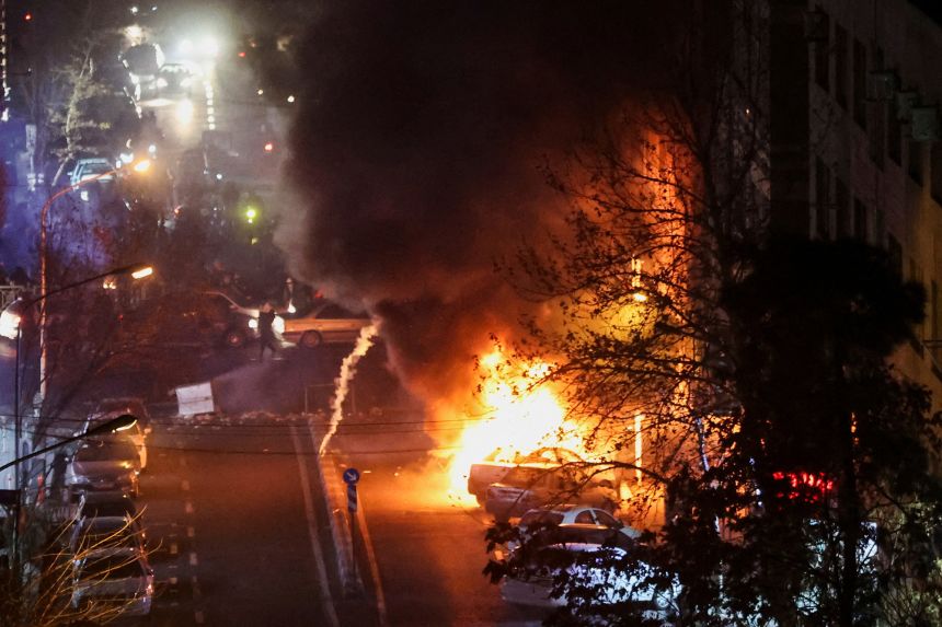 Cars burn in a street during a protest in Tehran, Iran, on January 8.
