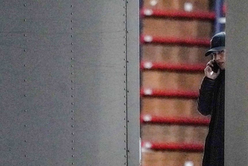 US Director of National Intelligence Tulsi Gabbard speaks on the phone while standing inside a vehicle loaded with boxes outside the Fulton County Election Hub and Operation Center after the Federal Bureau of Investigation executed a search warrant there in relation to the 2020 election, according to a law enforcement official familiar with the matter, in Union City, Georgia, on January 28.