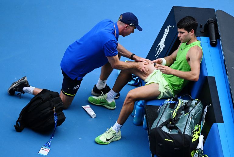 Spain's Carlos Alcaraz receives medical attention during his semi final match against Germany's Alexander Zverev