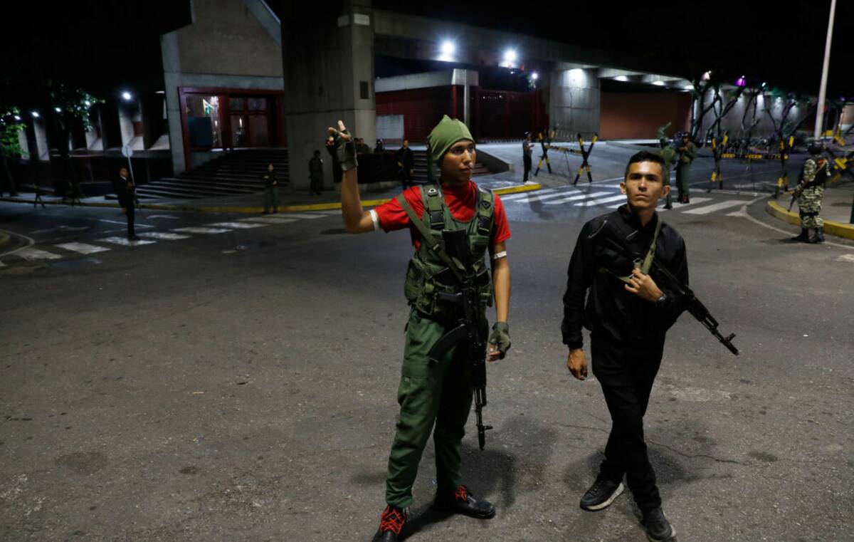 Members of the presidential guard stand outside the Miraflores presidential palace after explos ...