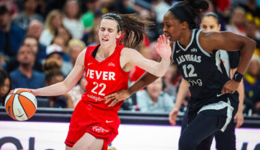 Indiana Fever guard Caitlin Clark (22) tries to fend off Aces guard Chelsea Gray (12) during a ...