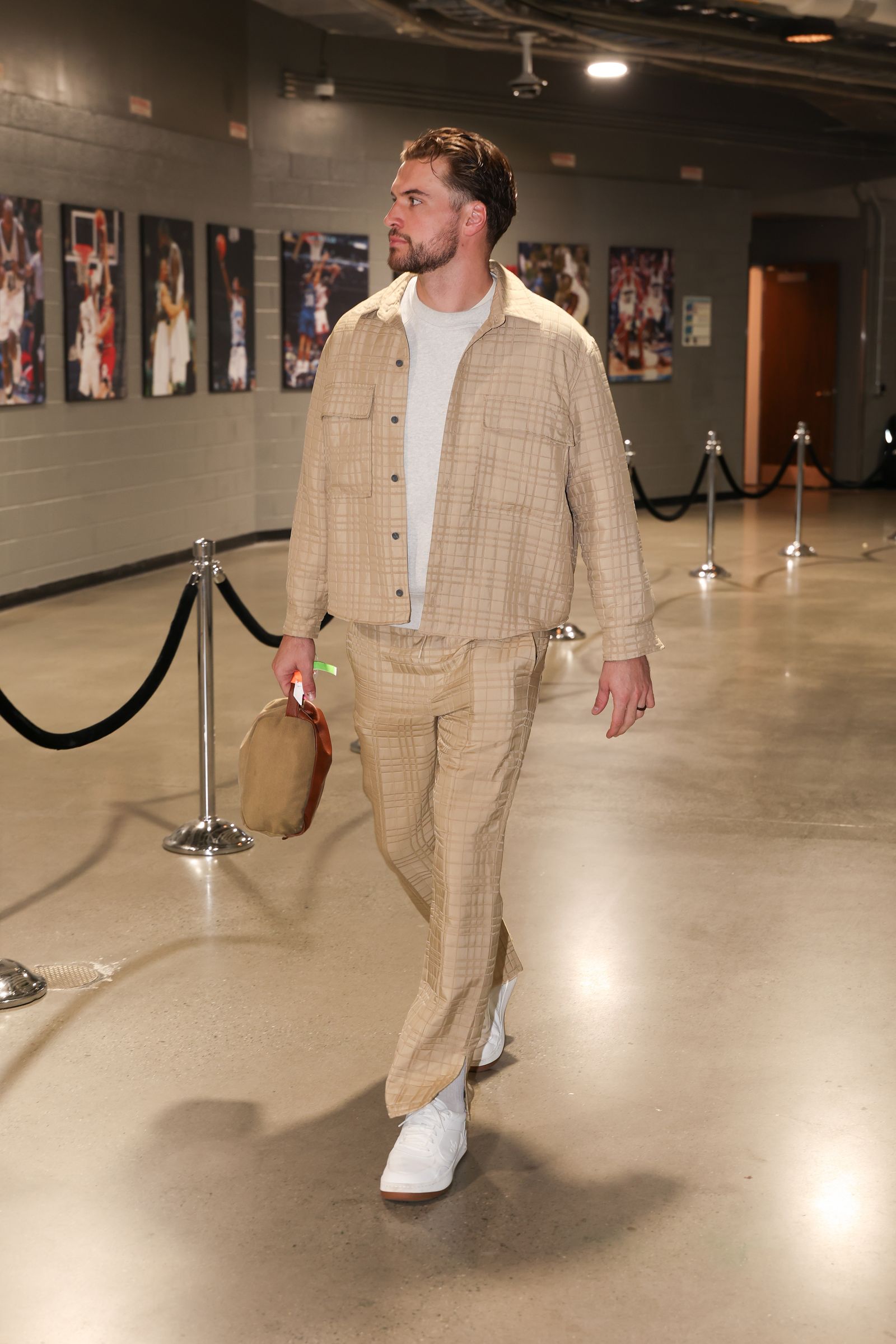 Image may contain T. J. Brennan Clothing Formal Wear Suit Adult Person Coat Accessories Bag Handbag and Standing