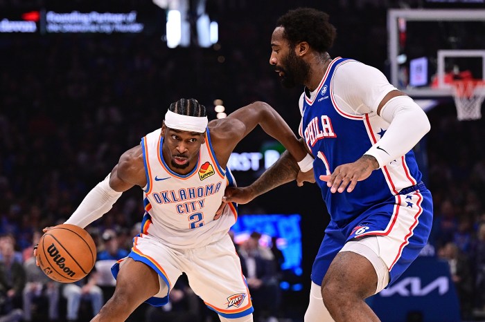 Shai Gilgeous-Alexander tries to drive past Andre Drummond