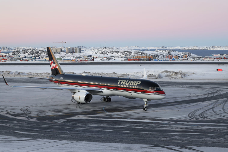 Trump aircraft in Nuuk, Greenland, with a pink sunset behind
