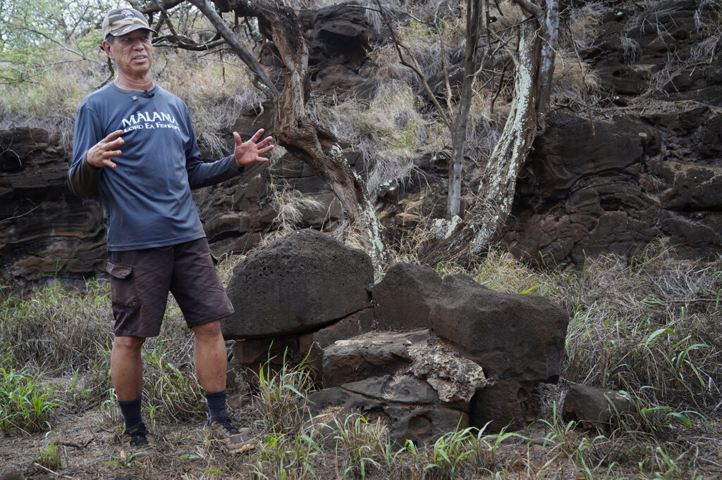 Protect Kahoʻolawe ʻOhana (PKO) Craig Neff talks about the miniature knight in shining armor the Navy placed on this rock between the Navy and PKO camps Monday, Jan. 5, 2026, in Hakioawa. PKO celebrates the 50th year of sovereign land. (Kevin Fujii/Civil Beat/2026)