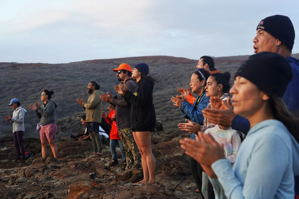 Protect Kahoʻolawe ʻOhana (PKO) chants the protocol for sunrise Tuesday, Jan. 6, 2026, in Hakioawa. PKO celebrates the 50th year of sovereign land. (Kevin Fujii/Civil Beat/2026)