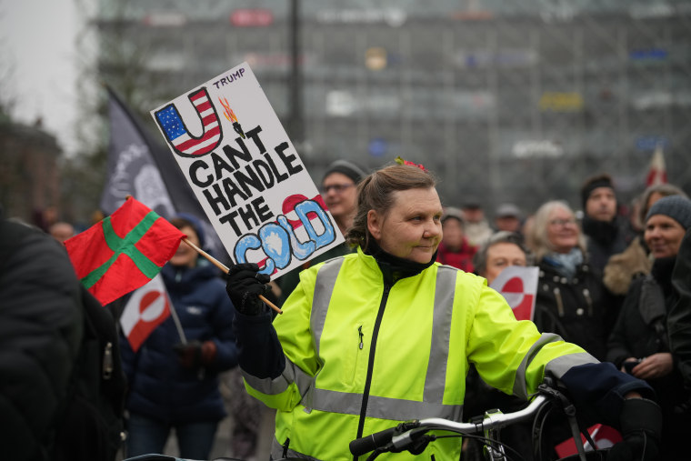 A Danish protester holds a sign at a protest in Copenhagen, Denmark, against the Trump administration’s Greenland push.