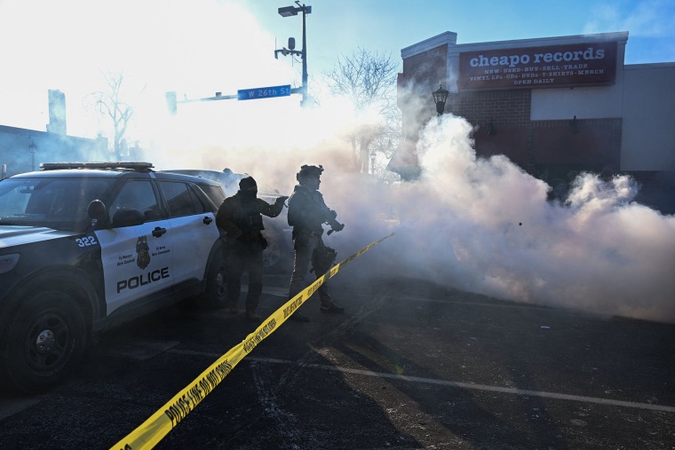 Tear gas is deployed by law enforcement as demonstators gather near the site of where state and local authorities say a man was shot and killed by federal agents earlier in the morning in Minneapolis, Minnesota, on January 24, 2026. 