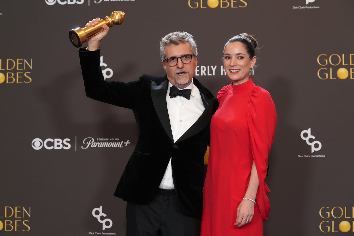 Kleber Mendonça Filho, left, and Emilie Lesclaux posed in the press room with the award for best motion picture – non-english language for "The Secret Agent" during the 83rd Golden Globes on Sunday at the Beverly Hilton in Beverly Hills, Calif.