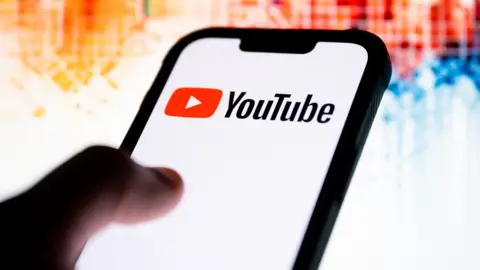 Getty Images  In this photo illustration, a YouTube logo seen displayed on a smartphone.