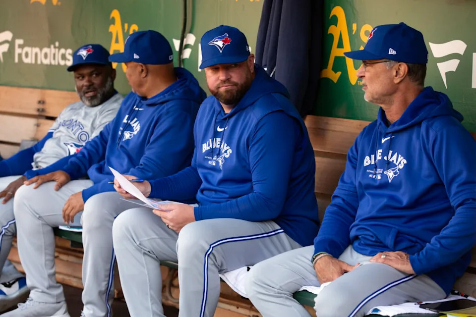 Jun 7, 2024; Oakland, California, USA; Toronto Blue Jays manager John Schneider (second from right) confers with bench coach Don Mattingly before taking on the Oakland Athletics at Oakland-Alameda County Coliseum. Mandatory Credit: D. Ross Cameron-Imagn Images