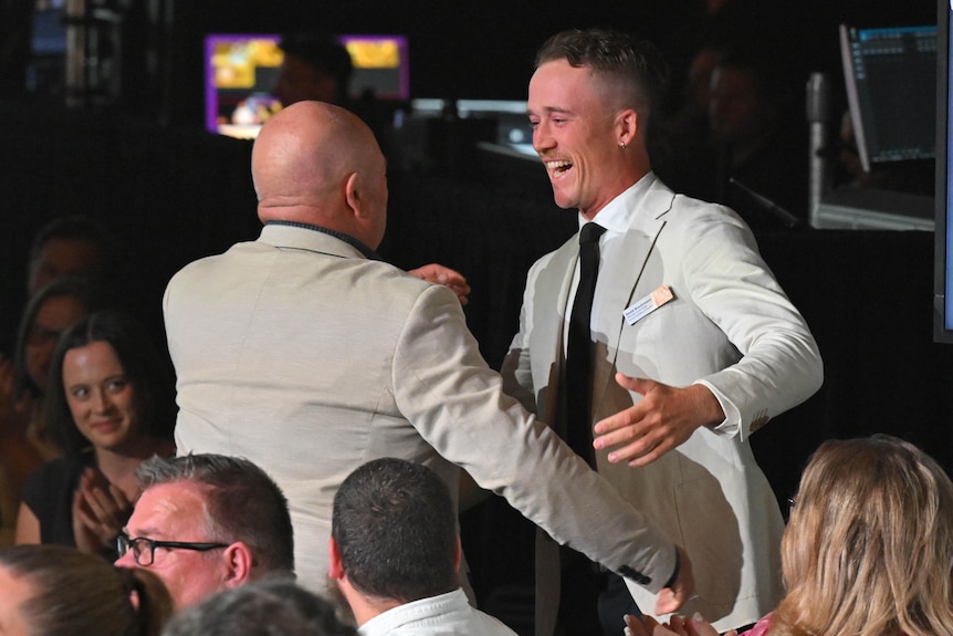 Ned hugs someone at the awards.