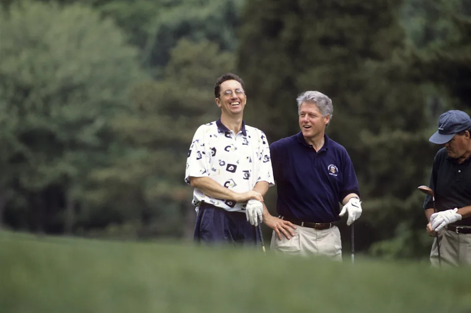 Sports writer Rick Reilly (L), seen with President Bill Clinton, has been a frequent critic of Trump and even wrote a book on his golf game. / Jacqueline Duvoisin / Sports Illustrated via Getty Images