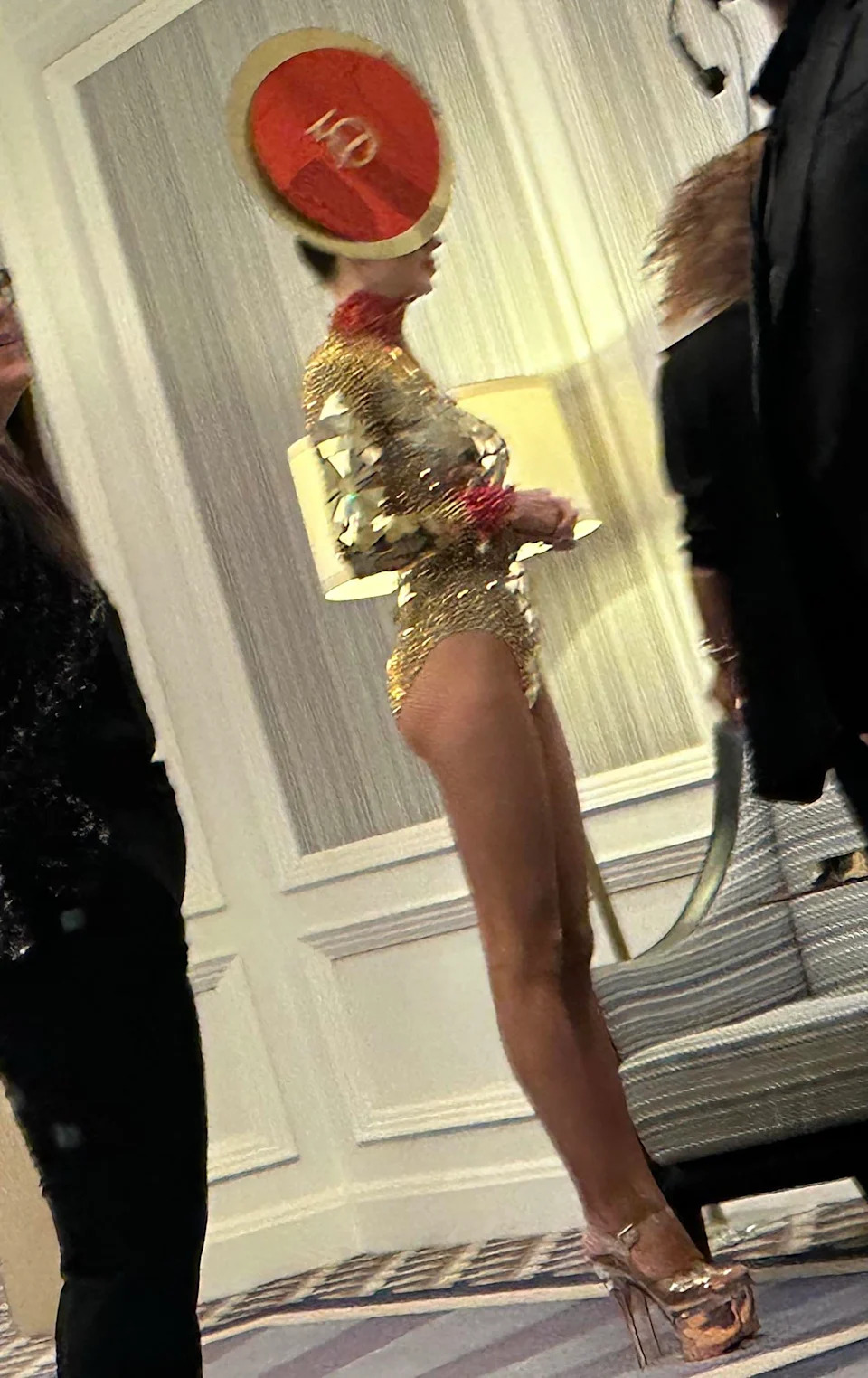 An entertainer in a gold bodysuit was seen in one photo. MEGA for PageSix.com