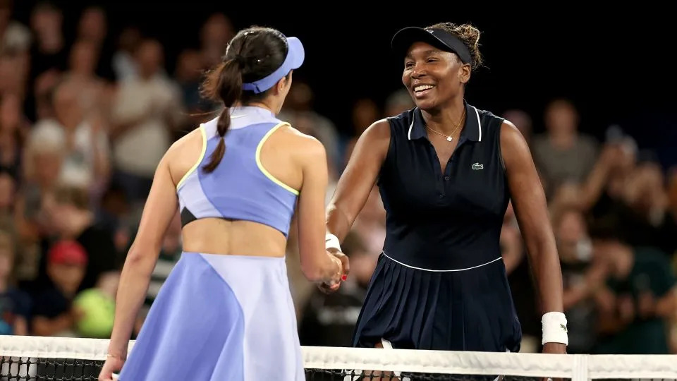 Serbia's Olga Danilovic shakes Venus Williams' hand after their women's singles match on day one of the Australian Open tennis tournament. - Martin Keep/AFP/Getty Images