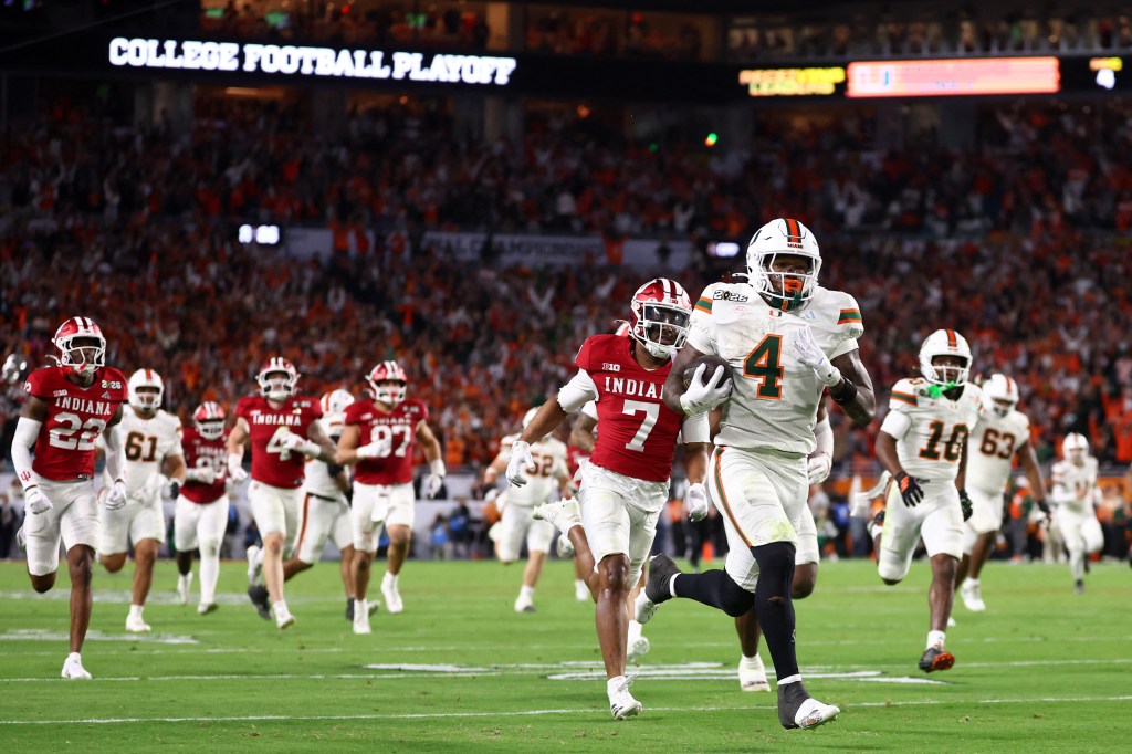 Miami Hurricanes running back Mark Fletcher Jr. (4) rushes for a touchdown past Indiana Hoosiers defensive back Louis Moore (7).