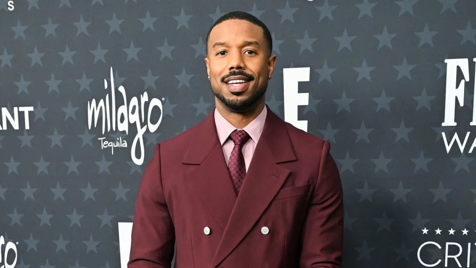 Best Actor nominee Michael B. Jordan in a burgundy double breasted Louis Vuitton suit. - Gilbert Flores/Variety/Getty Images