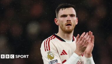 Liverpool left-back Andy Robertson applauds the fans