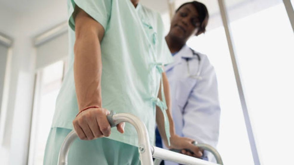 Patient attempting to walk. Getty Images.