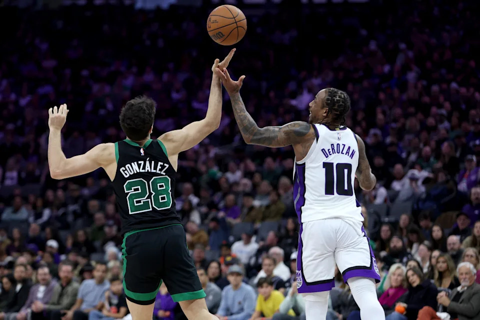 Jan 1, 2026; Sacramento, California, USA; Boston Celtics forward Hugo Gonzalez (28) and Sacramento Kings forward DeMar DeRozan (10) battles for the rebound during the fourth quarter at Golden 1 Center. Mandatory Credit: Dennis Lee-Imagn Images